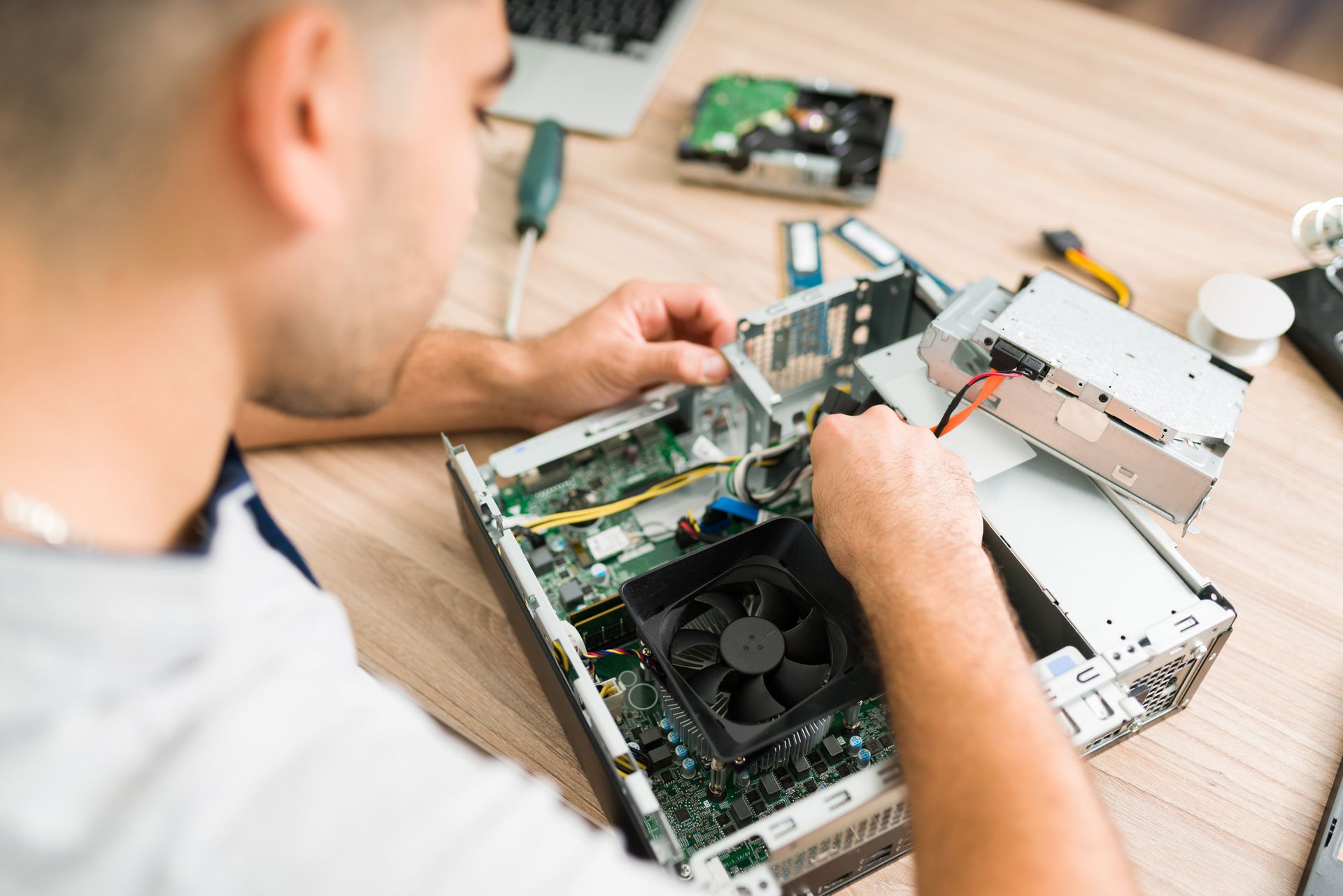 Technician repairing a desktop computer